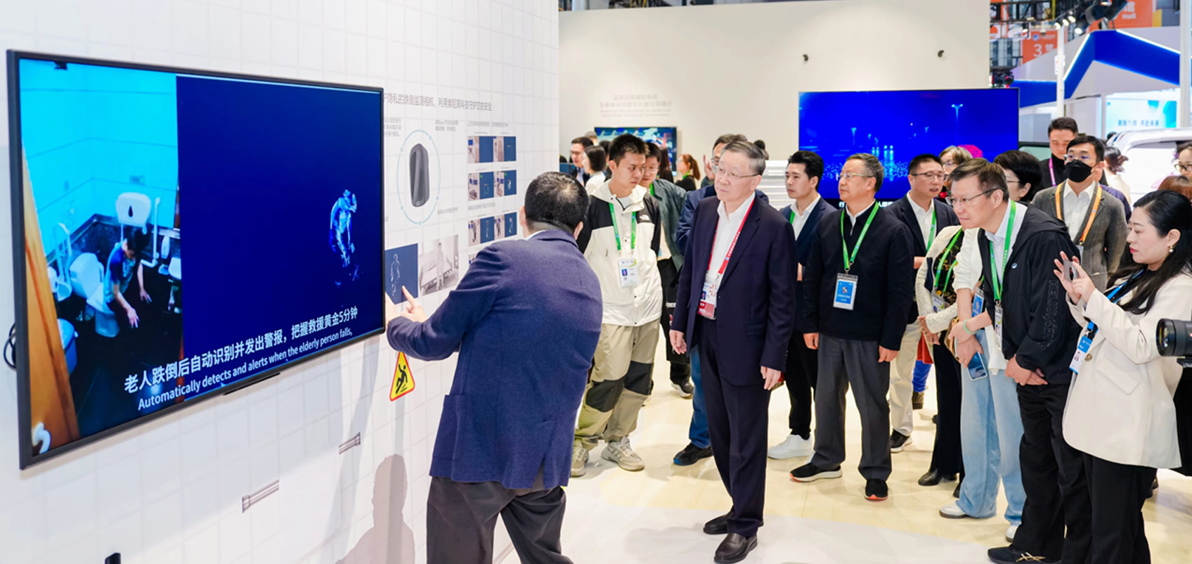 A group of visitors listening to an explanation at the Sony booth at CIIE.