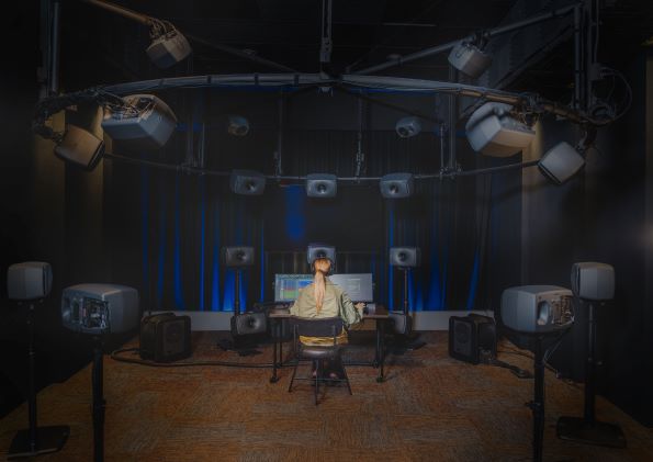 A creator working in a music studio using headphones